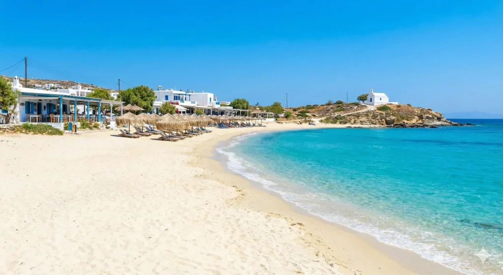 Stunning view of a sandy beach in Naxos, Greece, featuring crystal clear turquoise waters and traditional seaside tavernas.